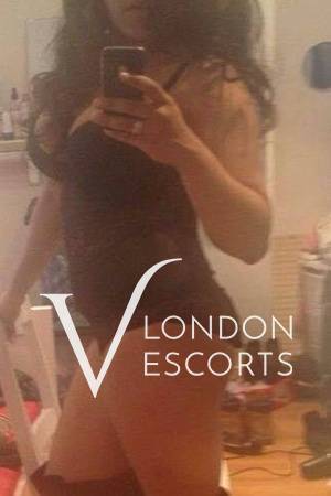 Sophia taking a selfie in front of a mirror in black lingerie