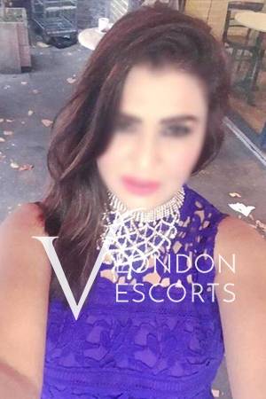 Aesha taking a selfie in a blue dress